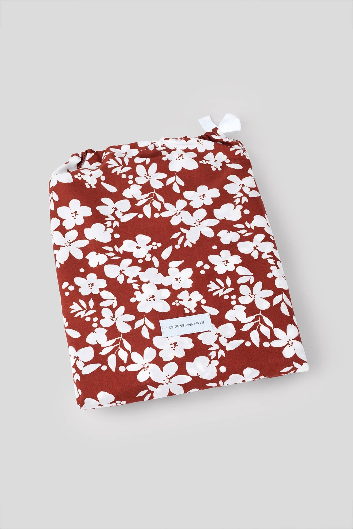 Rust red organic cotton percale duvet cover with lovely white flower seedlings